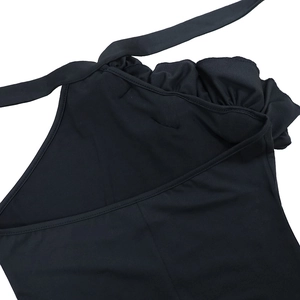 Detail of the black halter neck backless dress featuring elegant ruffles and tie design