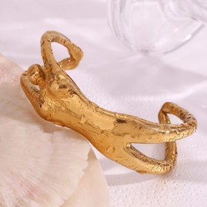 Detail view of 18K gold plated artistic body-shaped cuff bracelet with water droplets