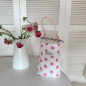 Close-up of pink polka dot mini tote bag with lace trim and soft ribbon handle