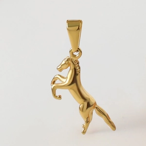 Detailed view of an 18k gold plated stainless steel horse pendant for jewelry making