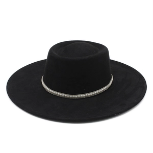 Detail of black faux suede wide brim fedora hat featuring elegant white pearl band decoration