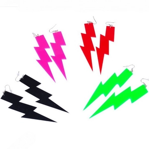 Macro shot of colorful acrylic lightning bolt earrings in pink, red, black and neon green