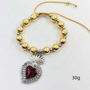 Detail of beaded bracelet with red sacred heart pendant and yellow woven cord, weight 30g