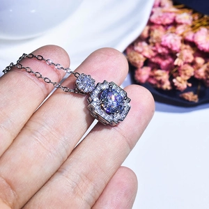 Close-up of a 2-carat square pendant necklace with round zircon on a white plate