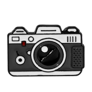 Cartoon camera enamel pin badge in black and white finish with red accents for accessories