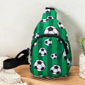 Close-up of a green cartoon football crossbody bag for kids on a wooden tray