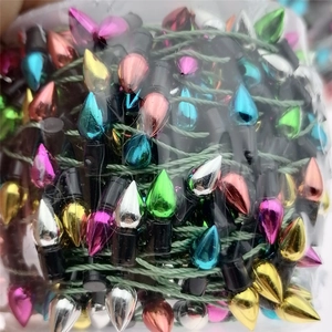 Macro detail of colorful metallic teardrop beads on green wire for Christmas decoration