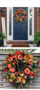 Detail of autumn wreath featuring orange pumpkins, silk flowers, and berries on a door