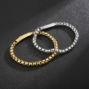 Detail view of gold and silver box chain bracelets with cylindrical plug-in clasps
