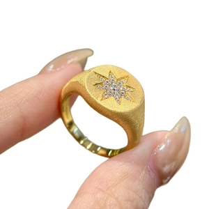 Gold plated oval signet ring with starburst motif and zircon inlay for women