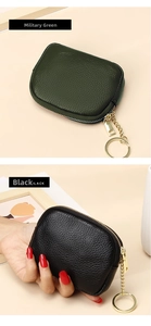 Detailed view of leather coin purses in military green and black with gold keychains