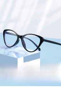 Detailed view of black cat-eye glasses frame with blue light blocking lenses on clear stand