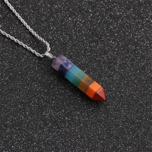 Detailed macro shot of a hexagonal chakra stone pendant with seven colorful natural gems