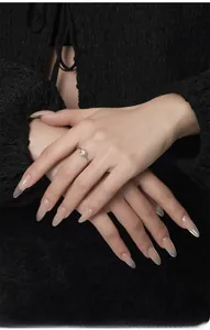 Close-up of S925 sterling silver ring featuring a round white agate stone on a model hand