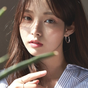 Minimalist S925 sterling silver twisted hoop earrings worn by model for elegant style