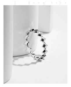 Macro shot of S925 sterling silver star ring on a white geometric minimalist pedestal