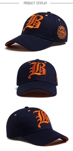 Three-angle view of a navy baseball cap with orange B embroidery and round mountain badge