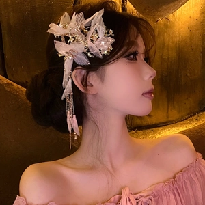 Elegant white fabric butterfly hair clip with golden fringe tassels and pearl accents