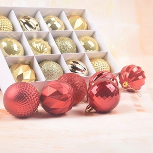Close-up of 12pcs red and gold Christmas ball ornaments with varied textures in a gift box