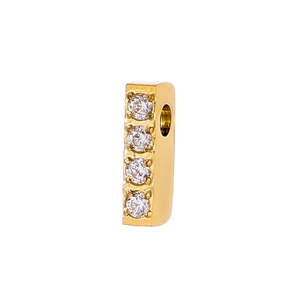 Macro detail of a 14k gold plated bar pendant featuring four inlaid sparkling zircons