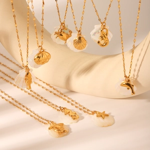 Detailed view of nine gold 18K starfish and seahorse ocean-themed shell necklaces