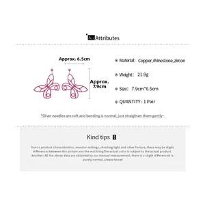 Detail view of pink butterfly earrings with dimensions 7.9cm x 6.5cm and cubic zirconia stones