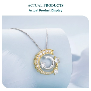 Detail view of a two-tone star and crescent moon pendant necklace with pavé diamonds