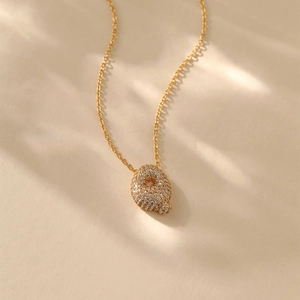 Detailed view of gold plated necklace with a sparkling cubic zirconia letter Q pendant