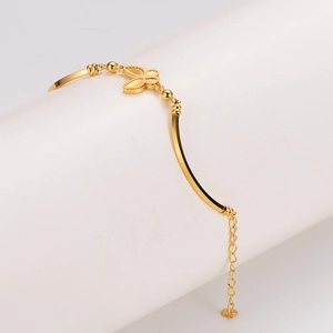 Polished golden butterfly bracelet with beaded chain and metallic charms for women