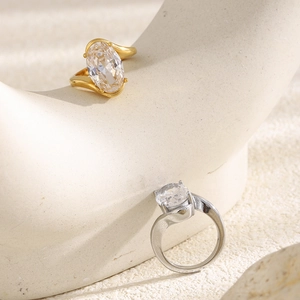 Macro shot of 18K gold plated ring with large oval zircon and modern S-curve band design