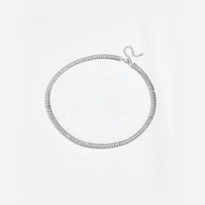 Detailed view of silver tennis necklace featuring rectangular cut transparent gemstones