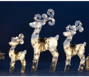 Detailed view of 3-piece lighted Christmas reindeer set with warm LED lights and flocked snow