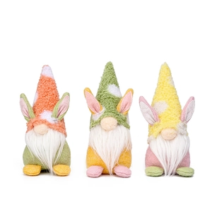 Three Easter faceless gnomes with rabbit ears in orange, green, and yellow plush fabric