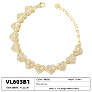Detail of gold brass heart link bracelet with cubic zirconia and lobster clasp closure