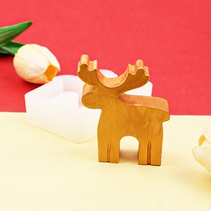 DIY Christmas elk silicone mold with a finished gold reindeer statuette for candles