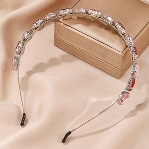 Detail of silver alloy headband featuring alternating red and pink heart shaped crystals