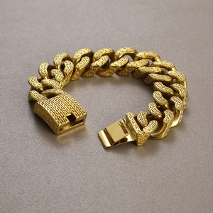 Macro shot of gold punk cuban chain bracelet featuring intricate embossed textures