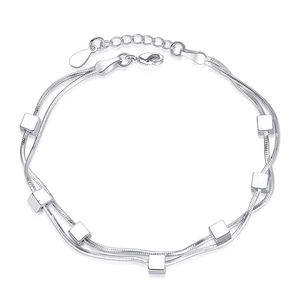 Silver double layer snake chain bracelet featuring six polished cube charms and star details