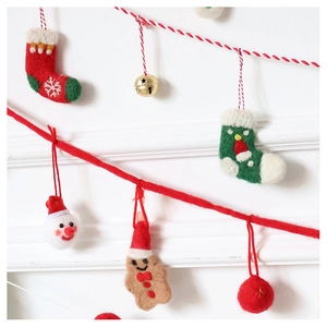 Detailed close-up of wool felt Christmas ornaments with soft texture on festive strings