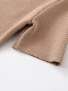 Detailed close-up of high-density camel knit fabric texture and hem stitching on short sleeve coat