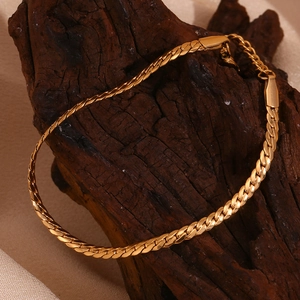 Detailed close-up of 18K gold plated stainless steel flat link chain with lobster clasp
