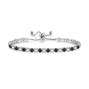 Detail of adjustable silver tennis bracelet featuring alternating black and white cubic zirconia