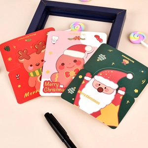 Close-up of colorful Christmas cards featuring reindeer, gingerbread man, and Santa designs
