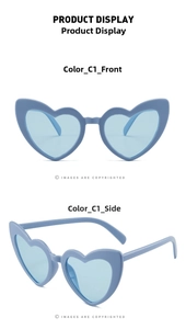 Detail view showing blue heart-shaped lenses and transparent frames of the sunglasses