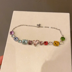 Macro view of French style bracelet with colorful multi-cut gemstones and silver chain