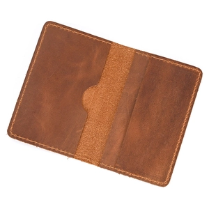 Macro view of dark brown crazy horse leather card holder with stitched internal card slots