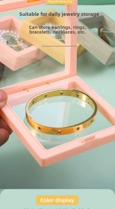 Detail view of pink PE film jewelry display box showing flexible membrane and gold bracelet
