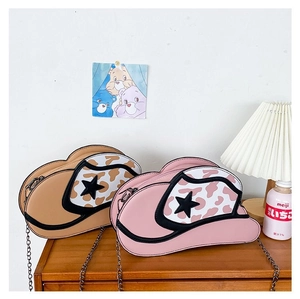 Detail of creative cowboy hat shaped crossbody bags in beige and pink with leopard print stars