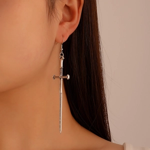Gothic vintage silver sword drop earrings shown on a model for punk street style look