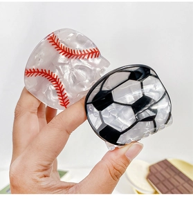 Detail of acrylic baseball and football hair claws with pearlescent marble texture